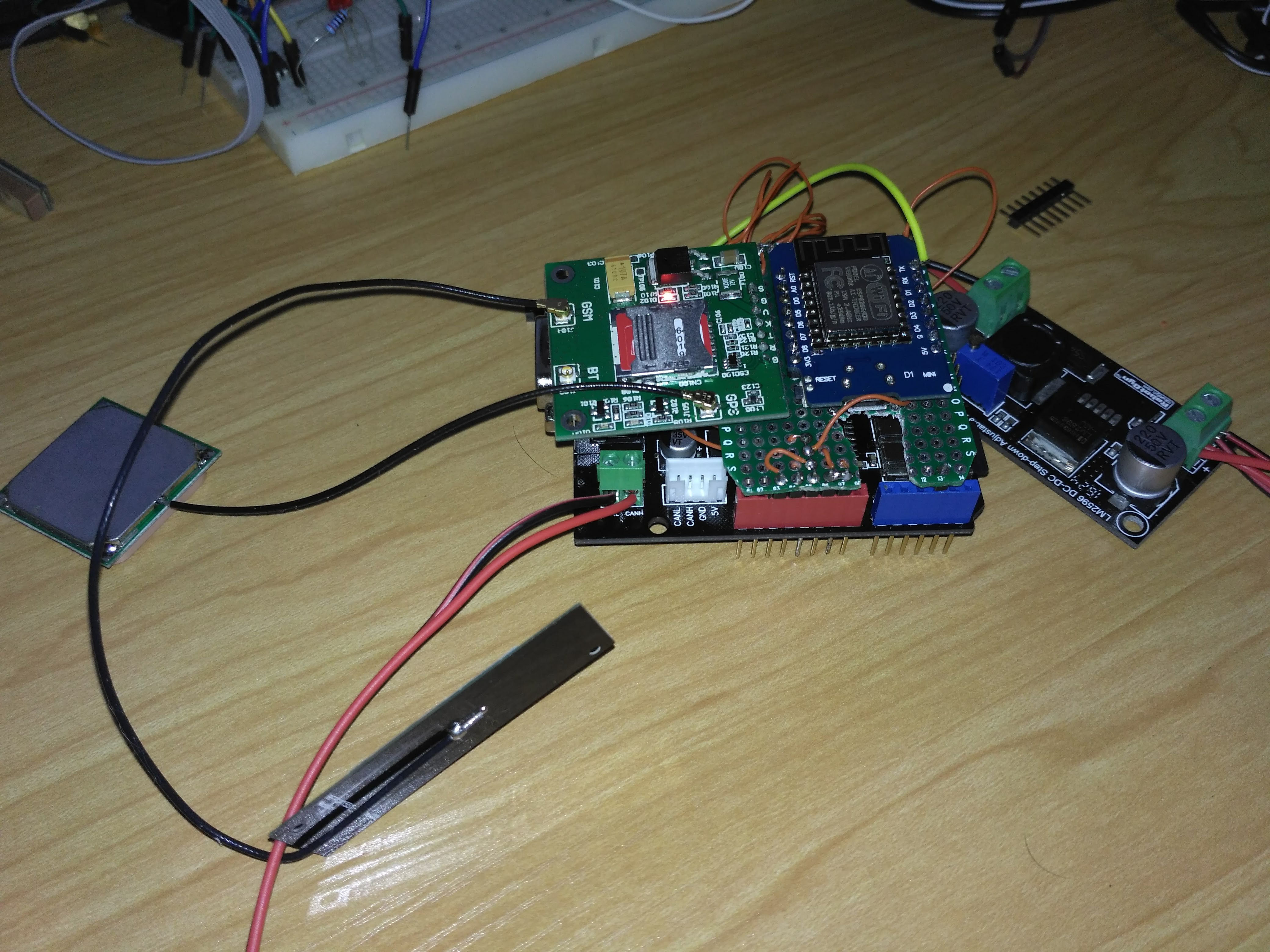 Integrated EV Black Box prototype — stacked board assembly with cellular module and GPS antenna